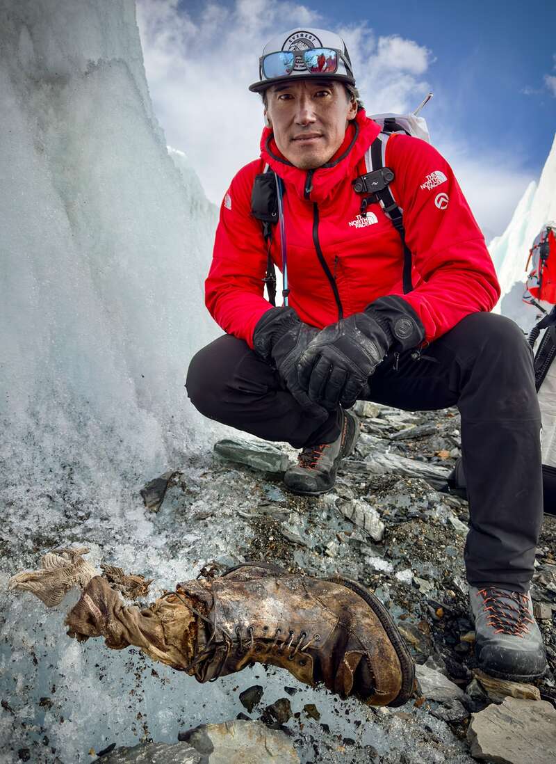 Jimmy Chin on Everest with Sandy Irvine’s partial remains emerging from the ice